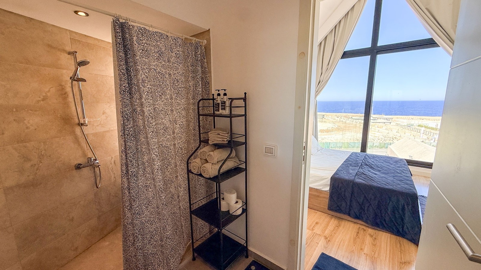Walk-in shower with a view into the bedroom