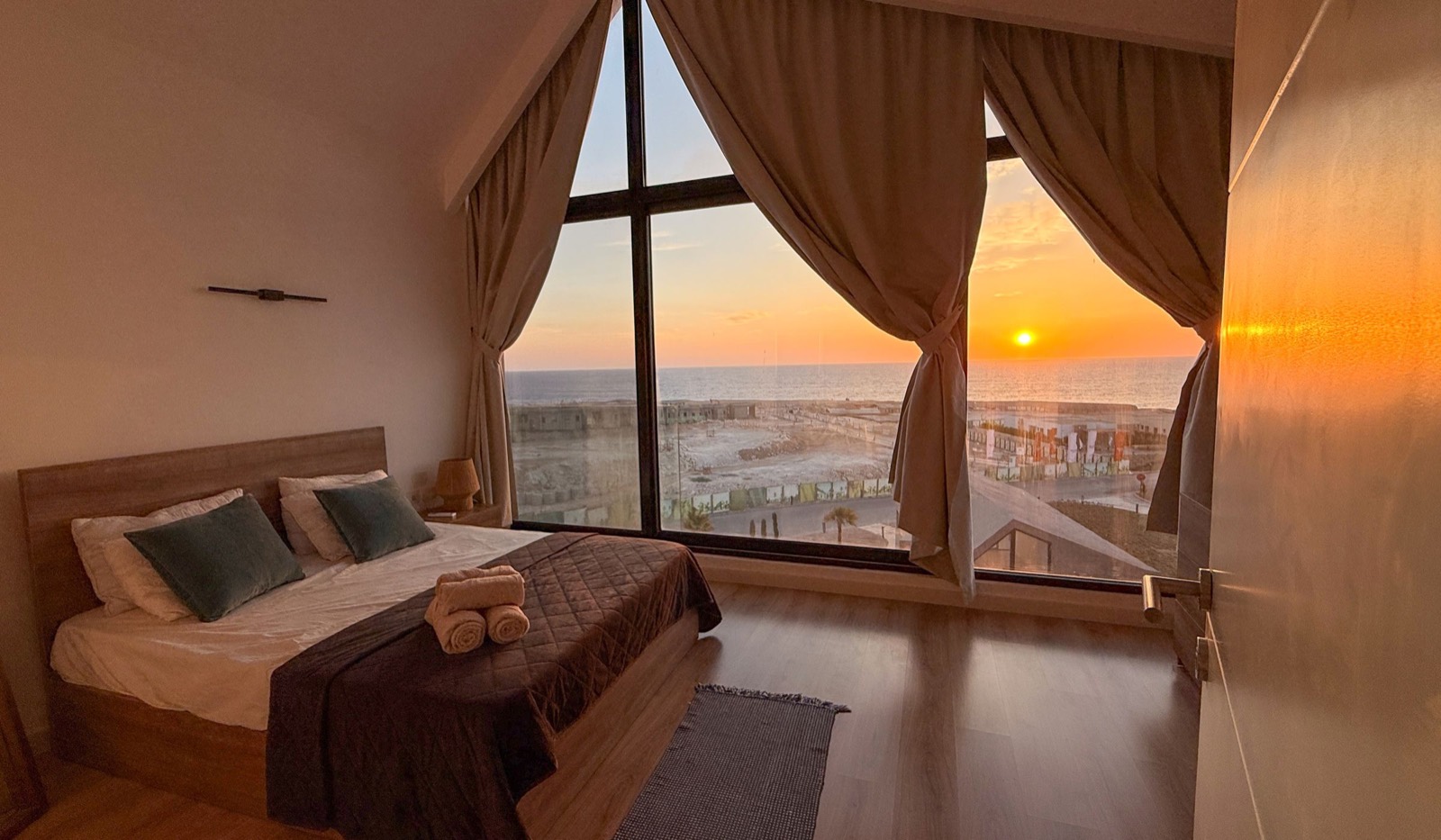 Master bedroom with the sun low over the sea