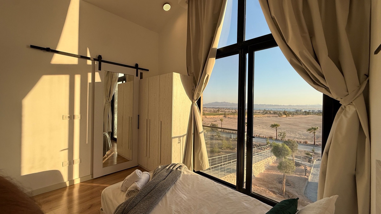 Twin bedroom with wardrobe and desert view