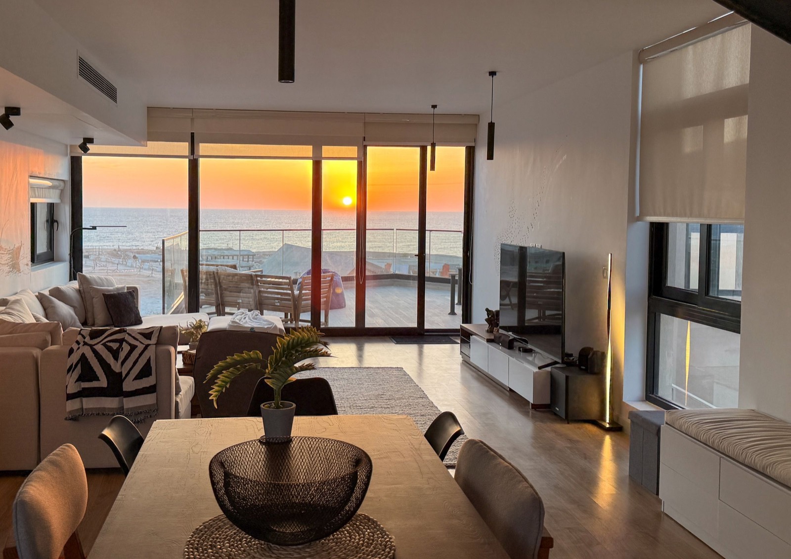 Dining table looking out to a sunset over the sea