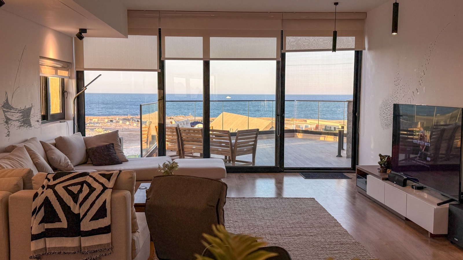 Living room opening onto the terrace and sea