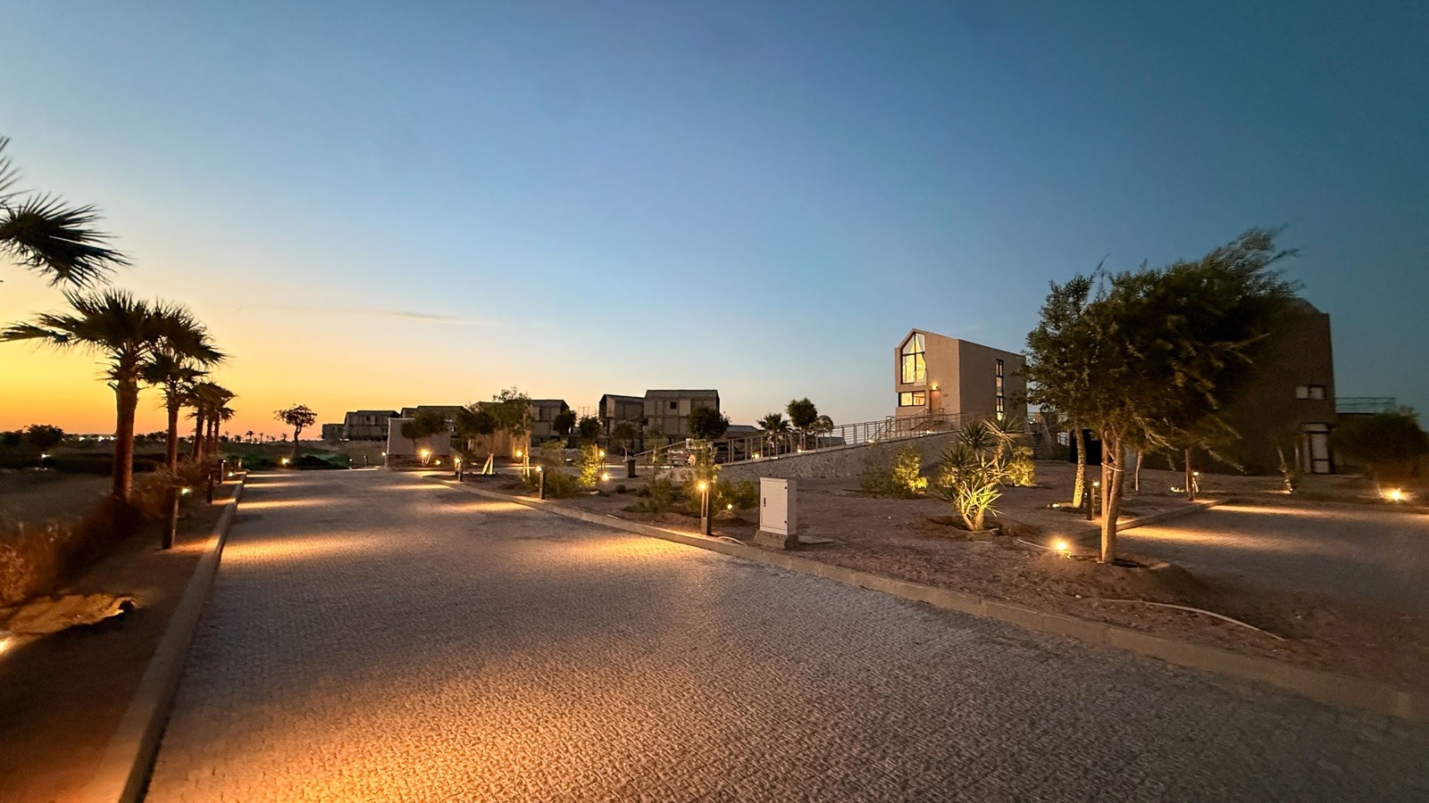 Lit road through Wadi Jebal at dusk
