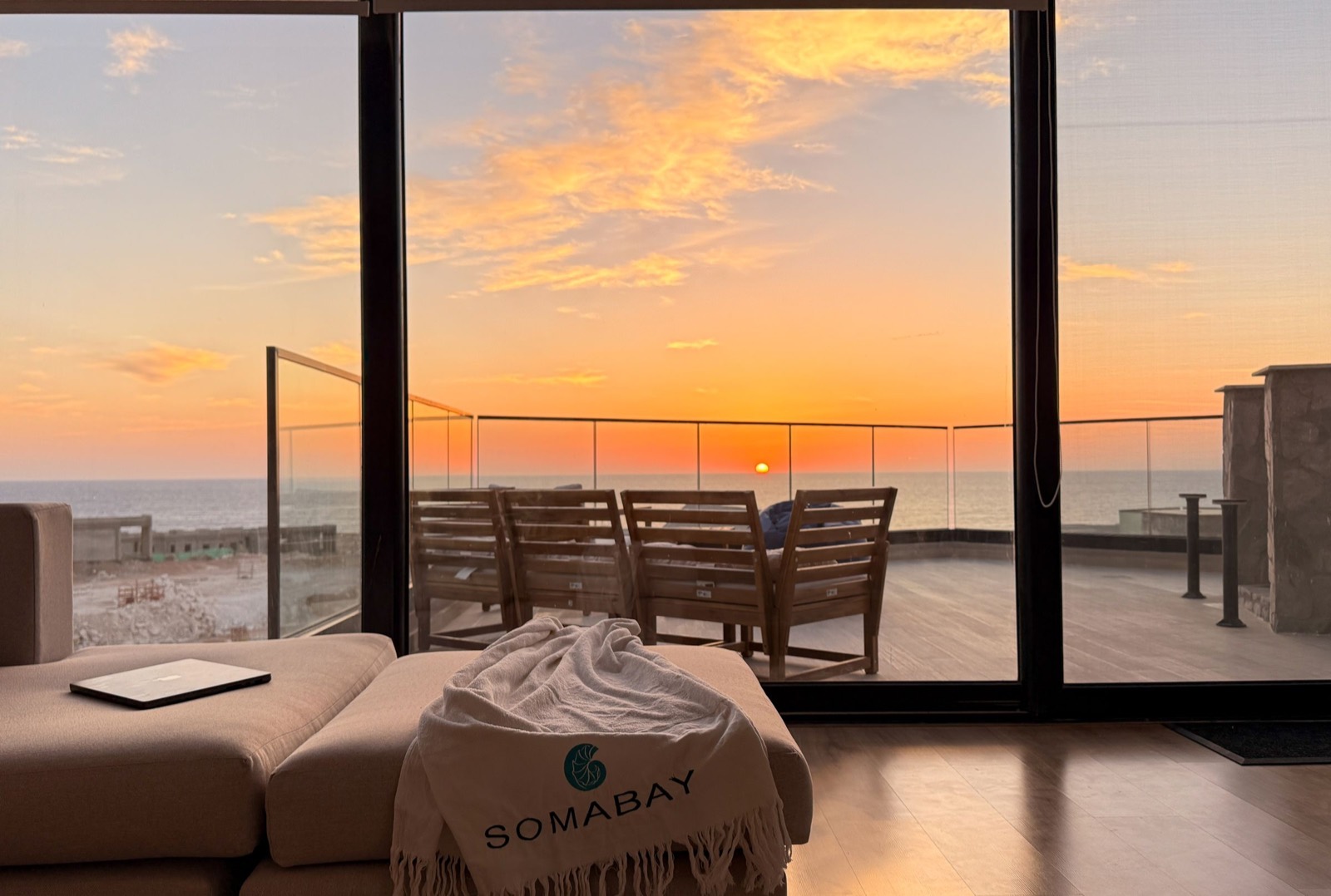 Daybed by the glass at sunset