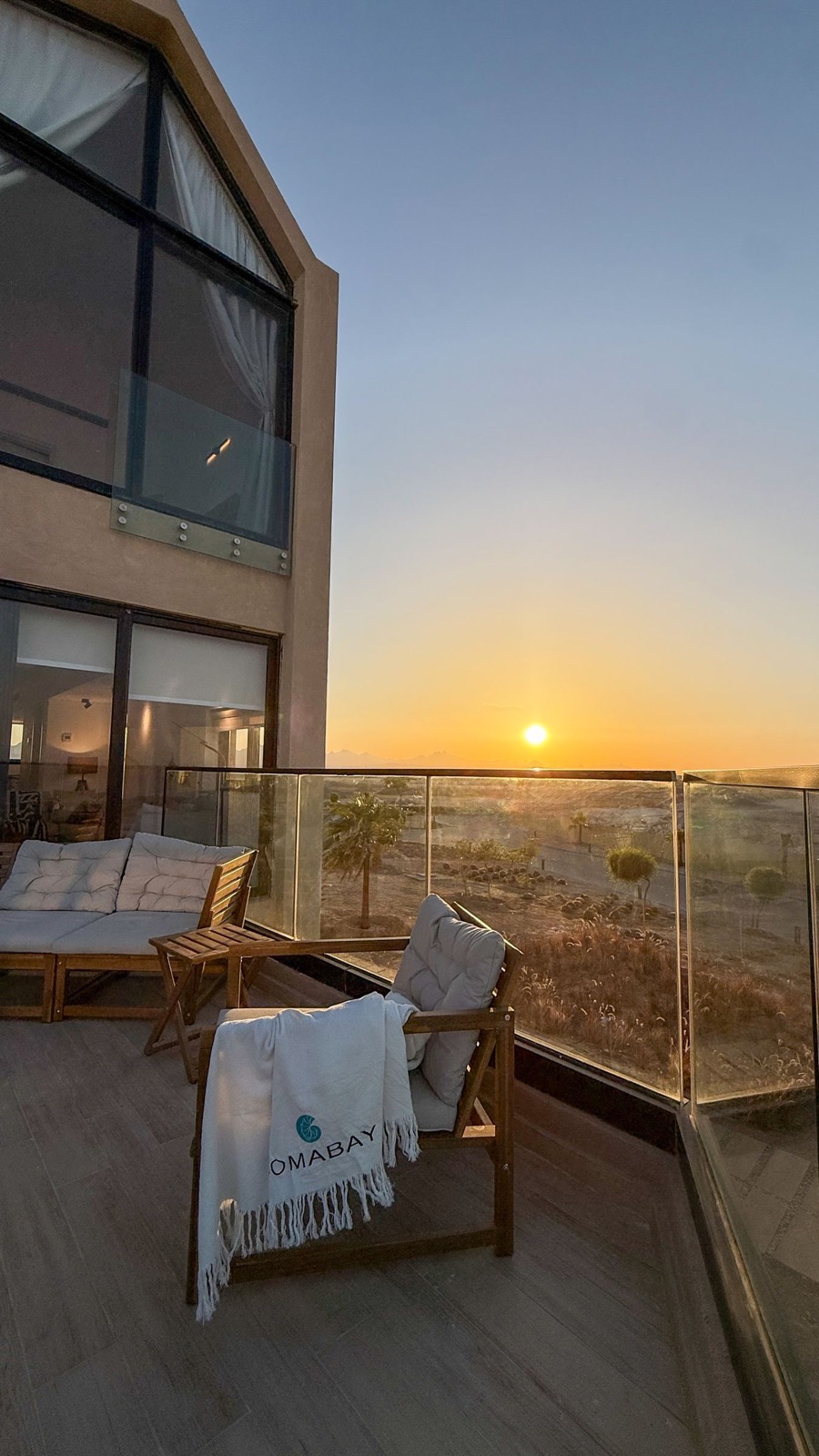 The lodge and terrace with the sun going down