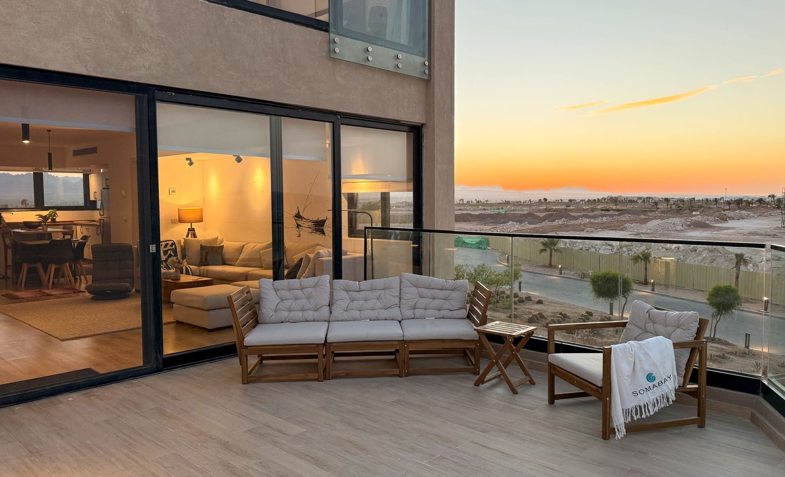 Terrace lit up at dusk with the living room glowing behind