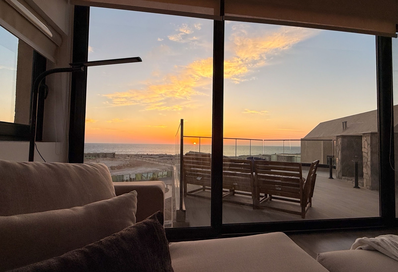 View from the living room onto the terrace at sunset